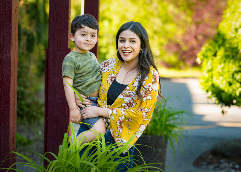 A happy woman holding her son on her hip