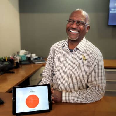 Darrell sits with the Fire Lingo tablet