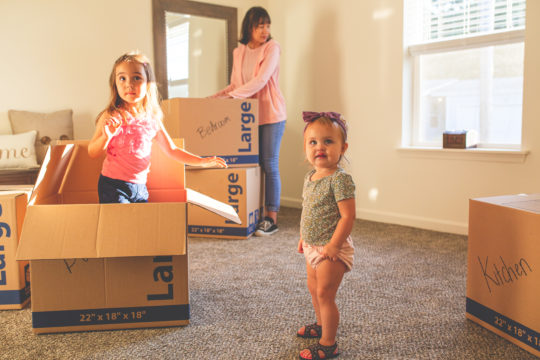 family unpacking boxes