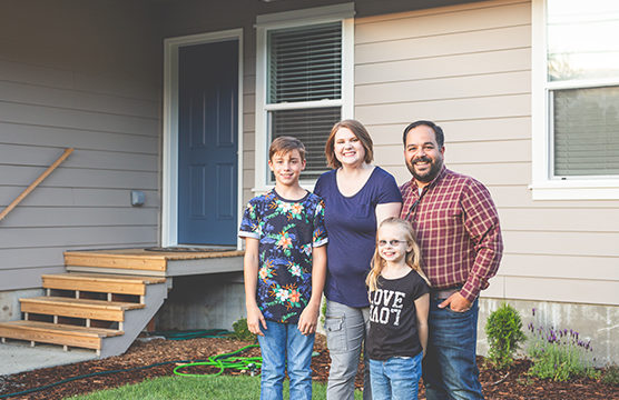 Family in front of house.