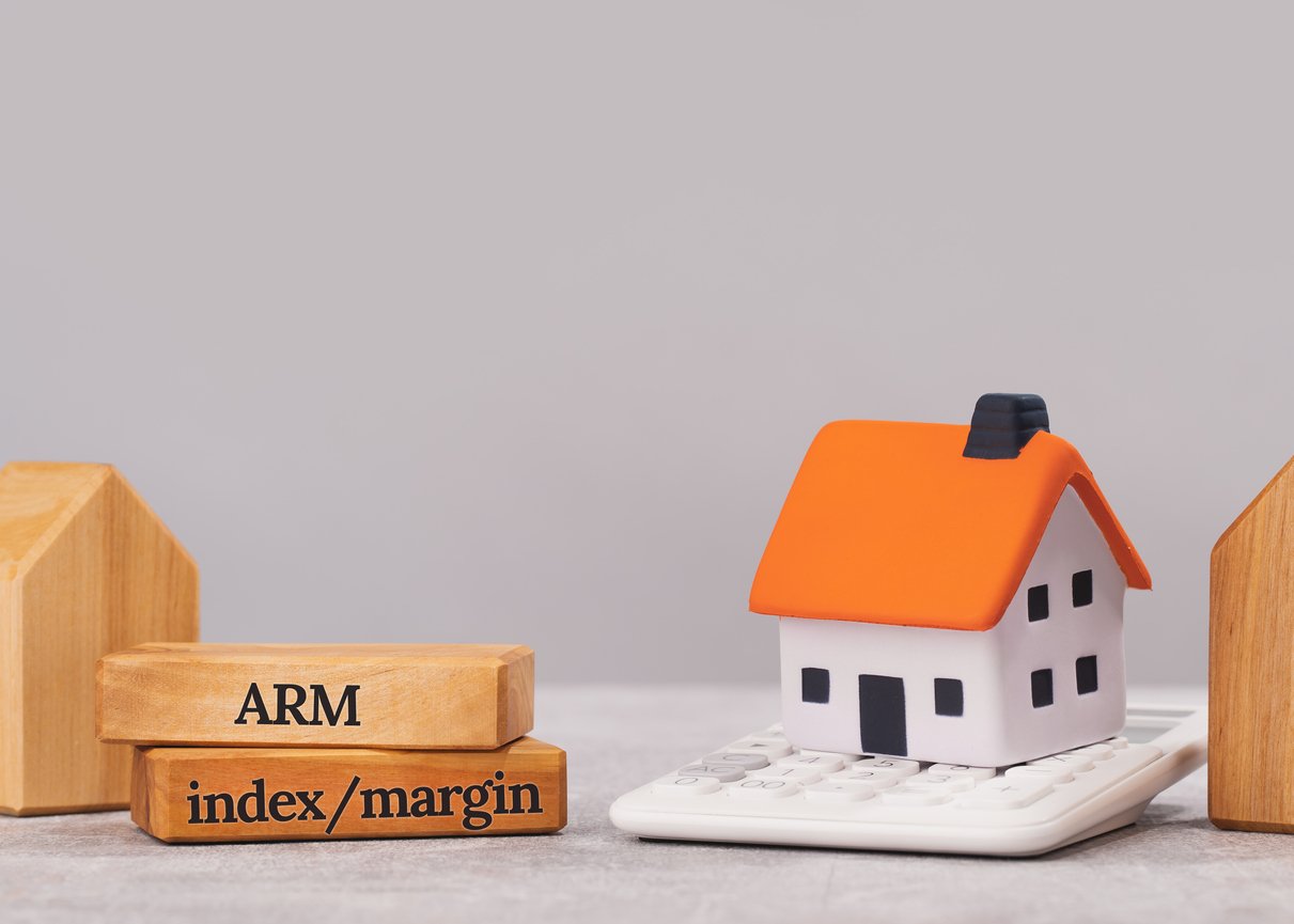 A toy house with blocks next to it that say "ARM" and "index/margin"