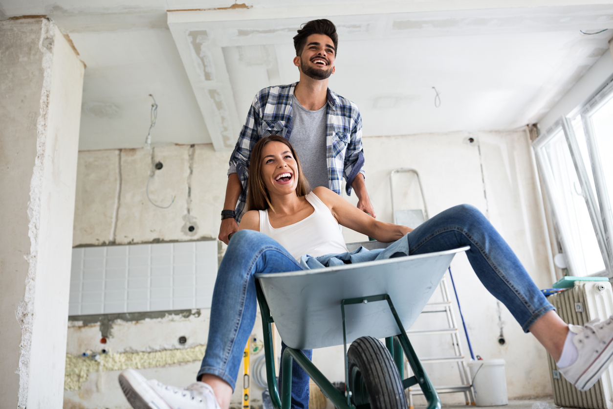A couple is having fun while they are renovating home