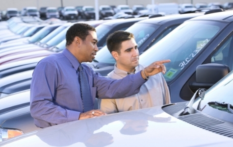 Two men at car dealership