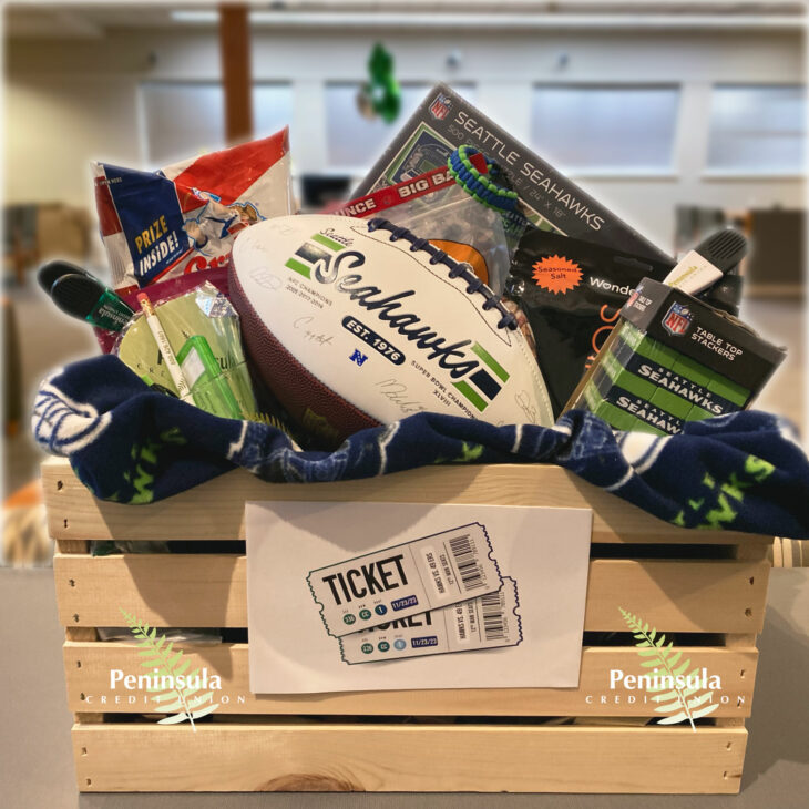 A basket with Seahawks gear and two tickets to an upcoming game