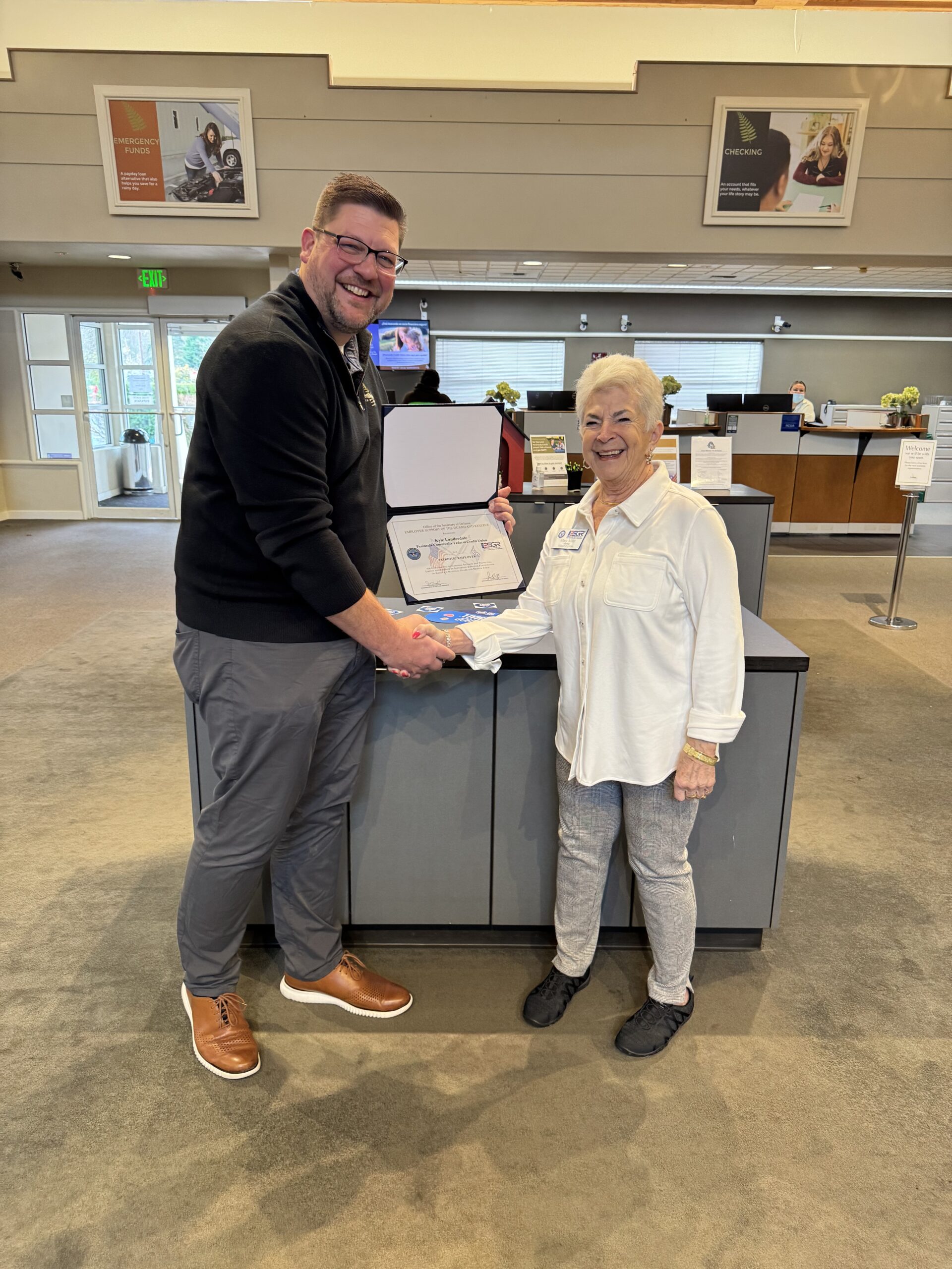 Kyle Lauderdale accepts the Patriotic Employer Award from Mary Miller from the ESGR