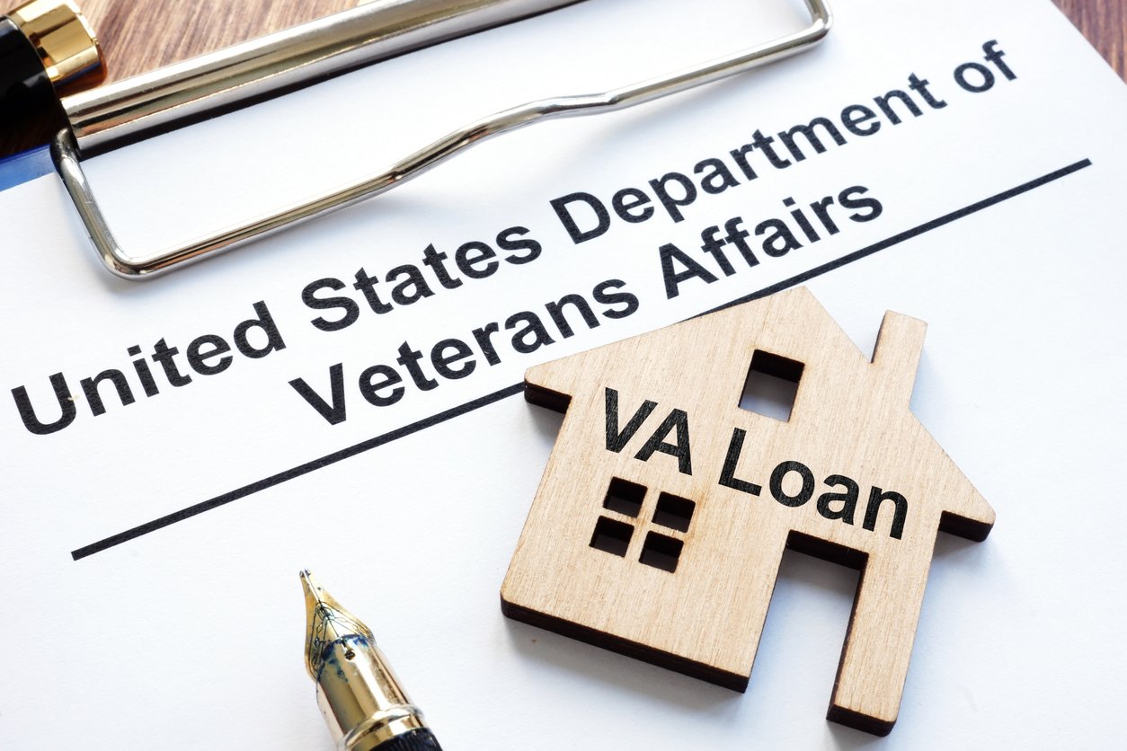 A paper that says "United States Department of Veterans Affairs" with a wooden house on it that says "VA Loan"