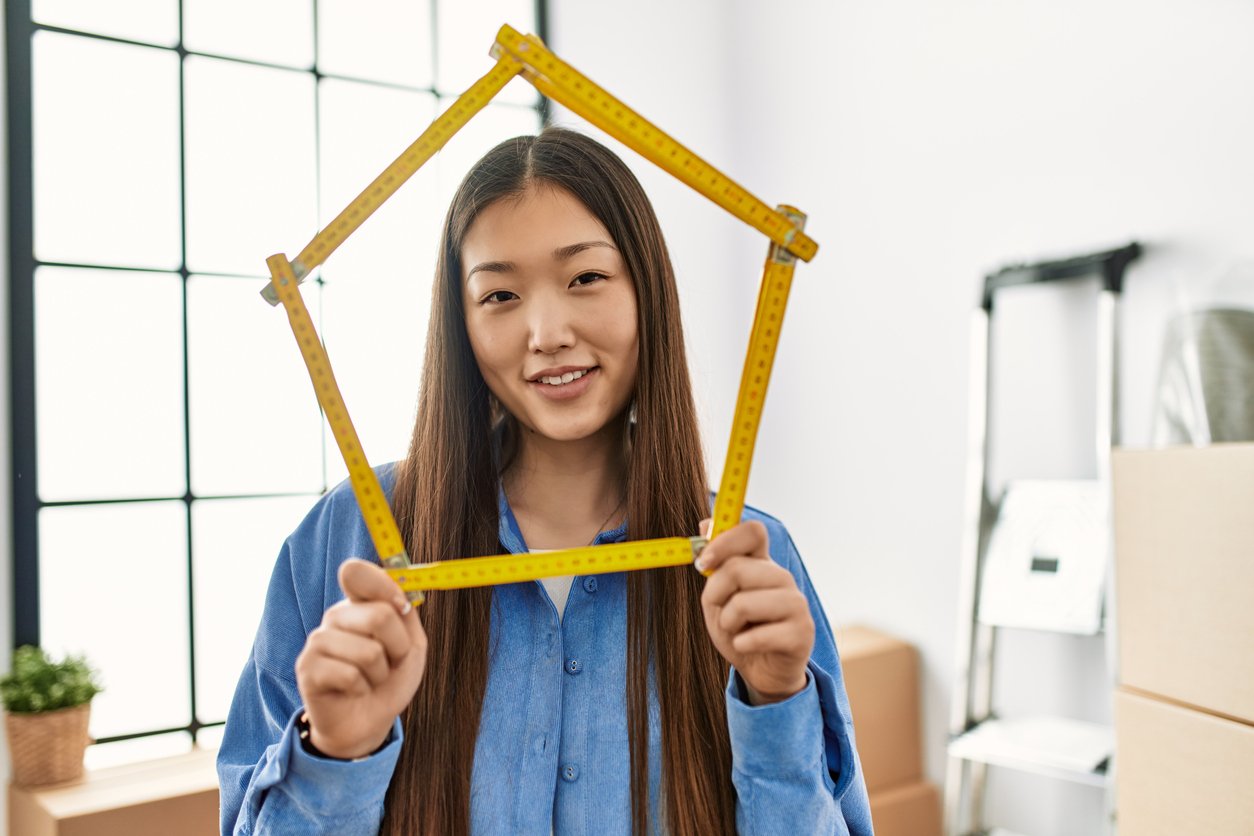 A woman smiling with a measuring tape bent into a circle