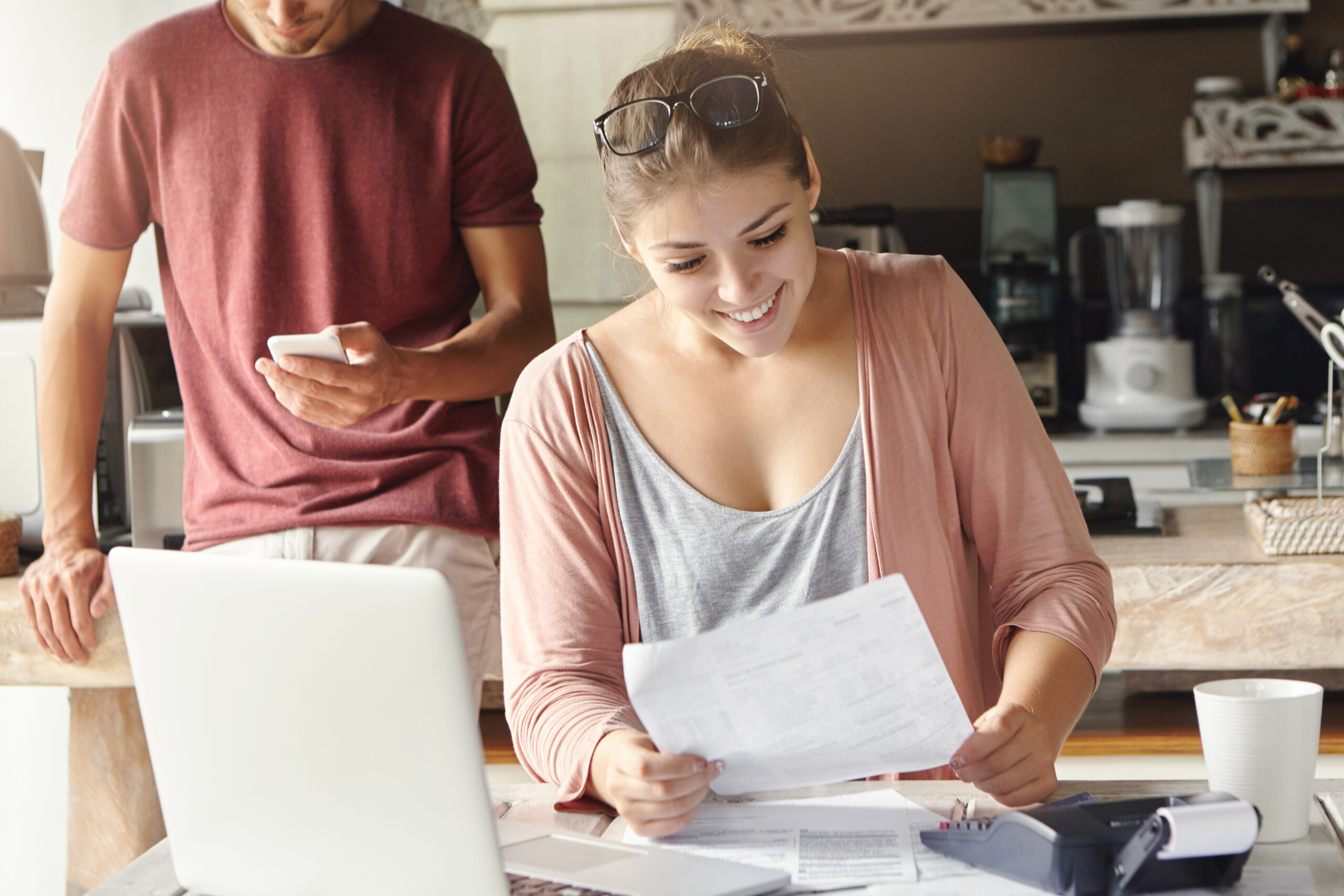 A happy young couple paying bills together