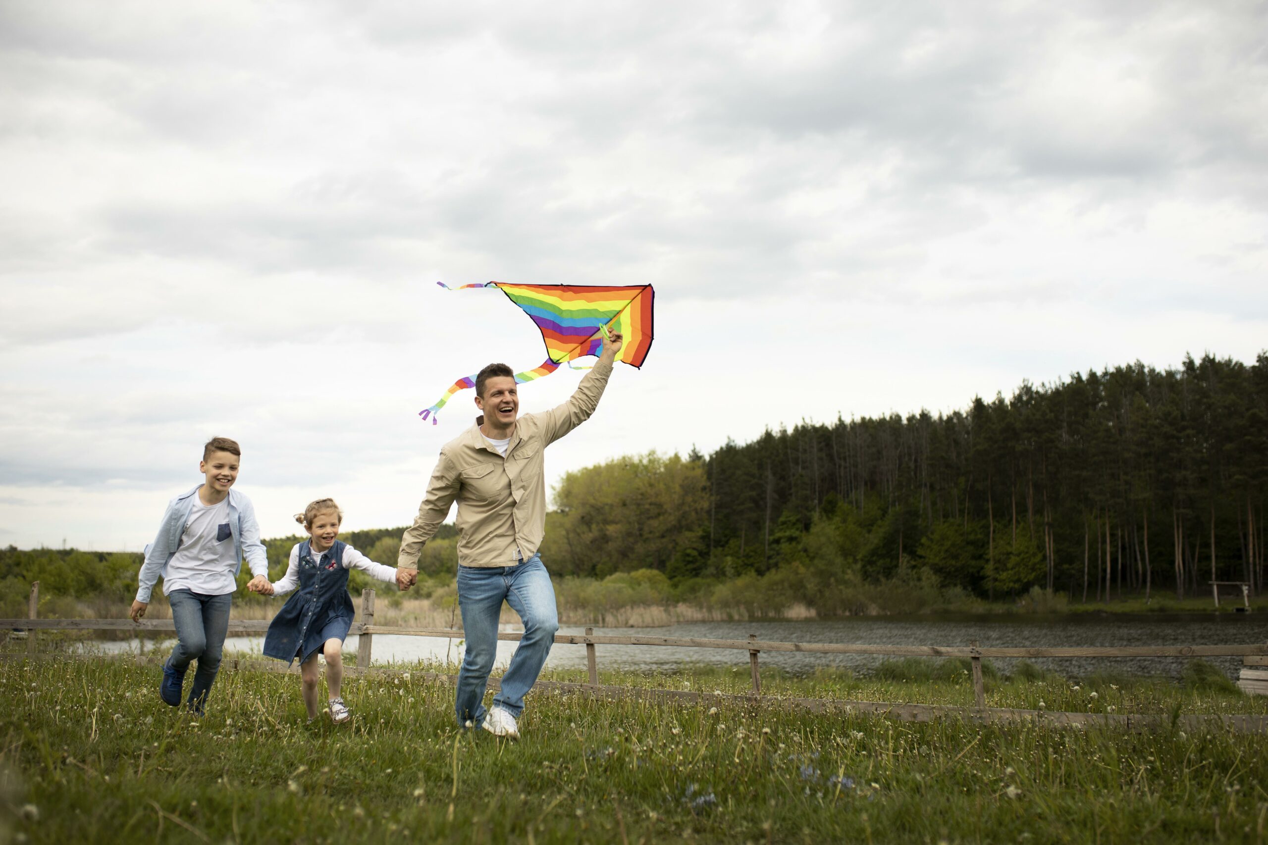 A father and kids playing with a kite