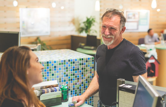 Bank teller smiling at an older man