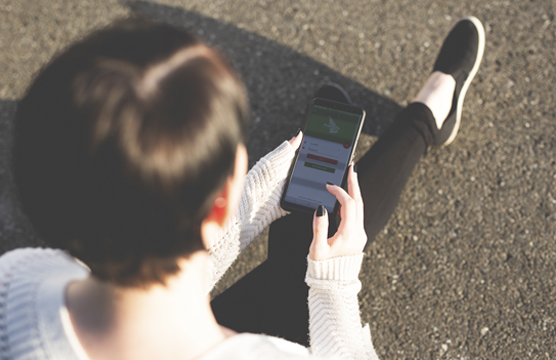 View from behind someone on their smartphone
