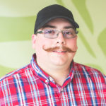 Smiling man with hat and mustache