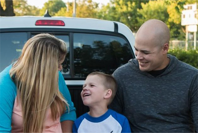 Couple smiling at their son