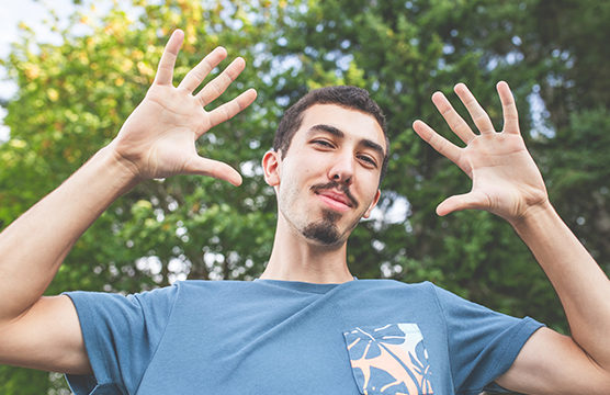 man holding up both hands