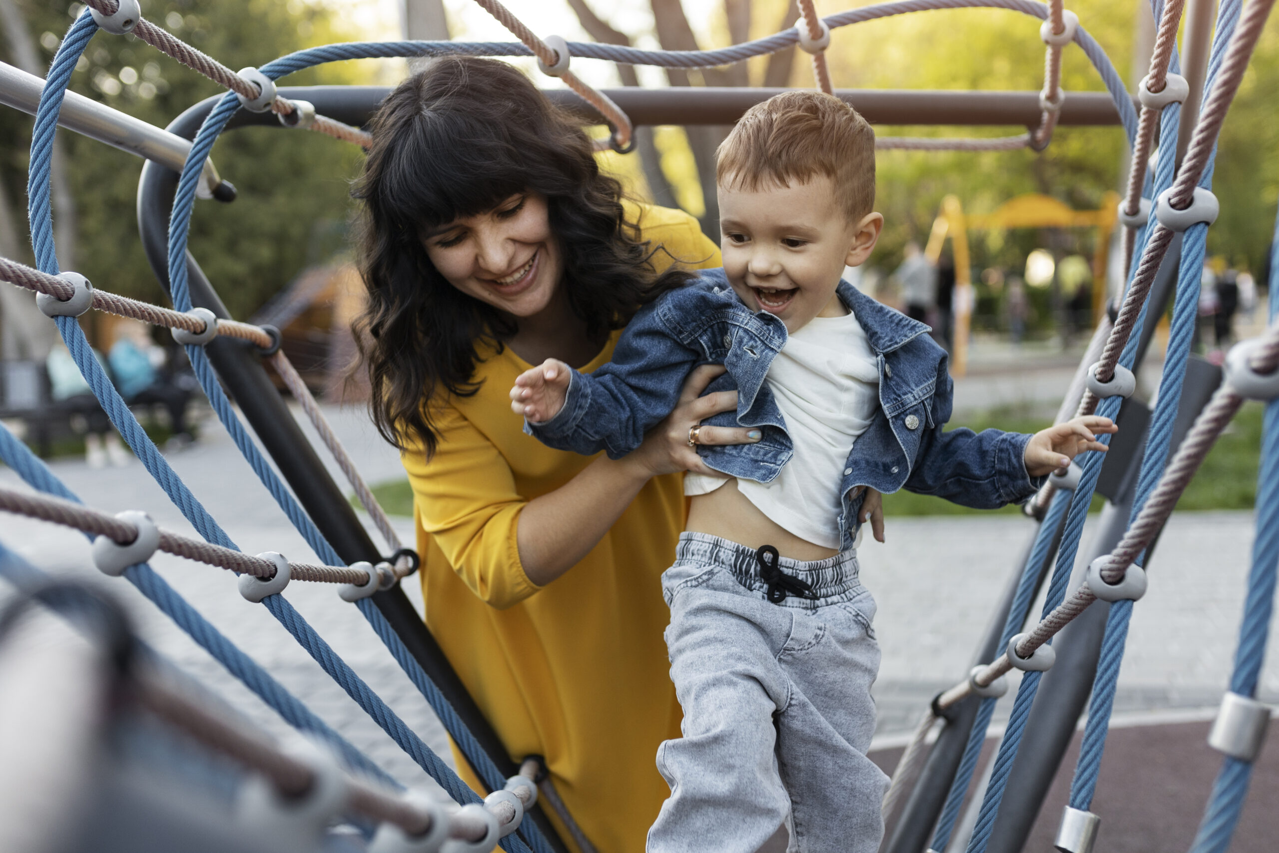 A mom holding her child on a playground