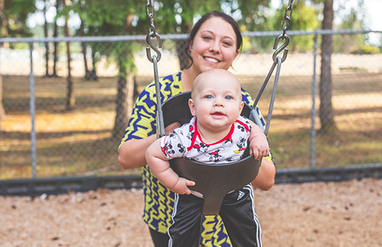 Mother with child in swing