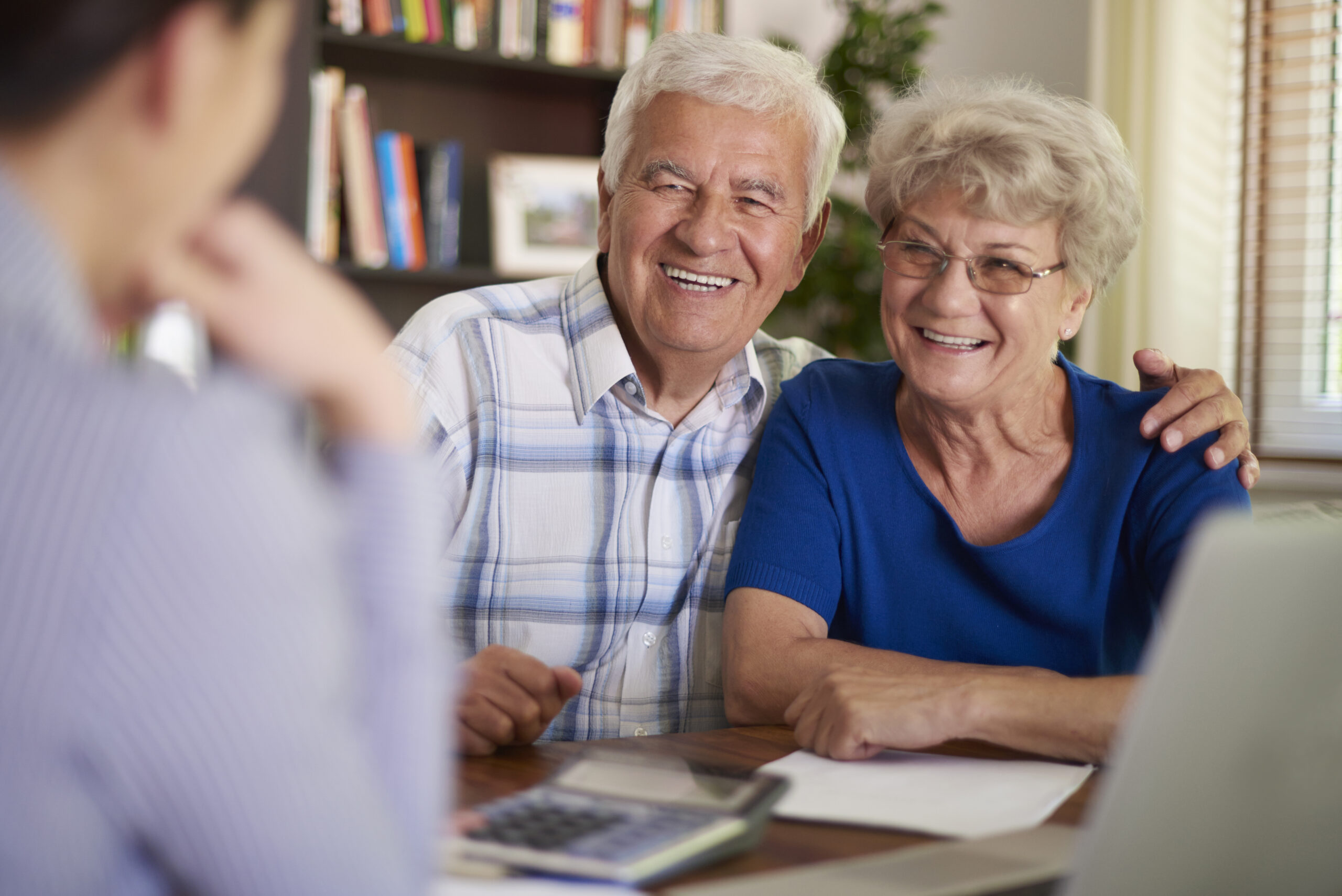 A happy couple talking to a financial planner