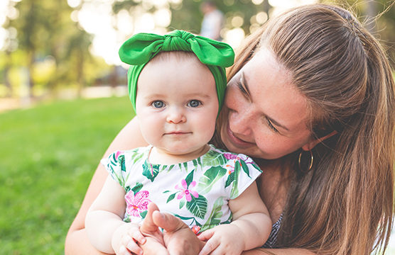 smiling mother holding baby